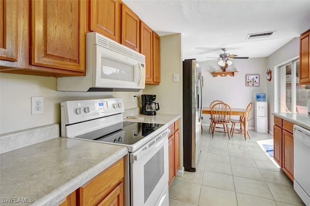 kitchen with white appliances, visible vents, light countertops, and light tile patterned flooring