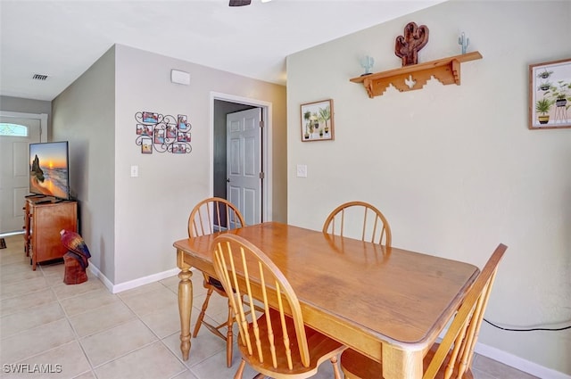 dining area with light tile patterned floors, baseboards, and visible vents