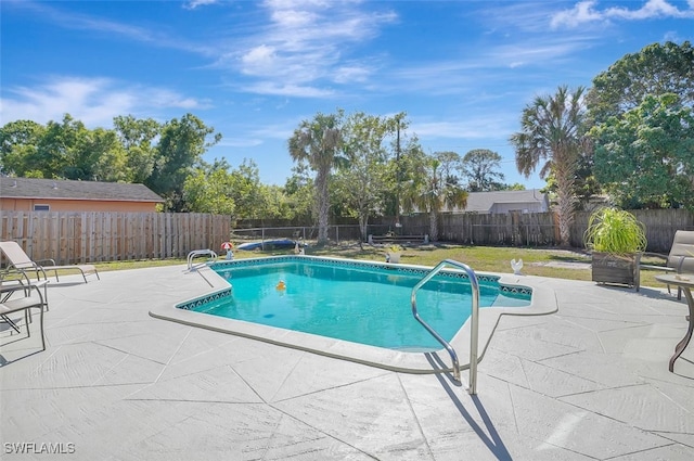 view of swimming pool featuring a patio, a lawn, a fenced backyard, and a fenced in pool