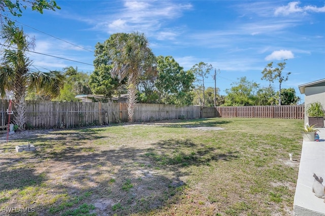 view of yard with a fenced backyard