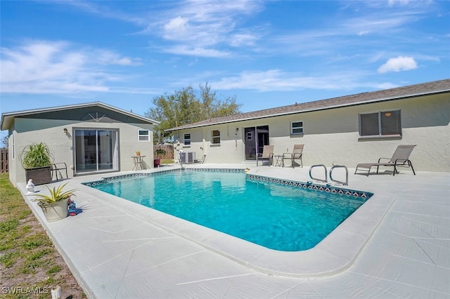 outdoor pool featuring a patio area and fence