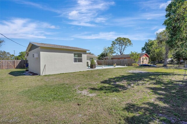 view of yard with a patio area and a fenced backyard