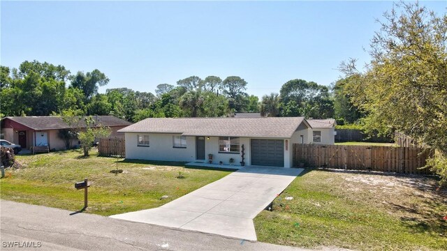 single story home with driveway, a garage, fence, a front lawn, and stucco siding