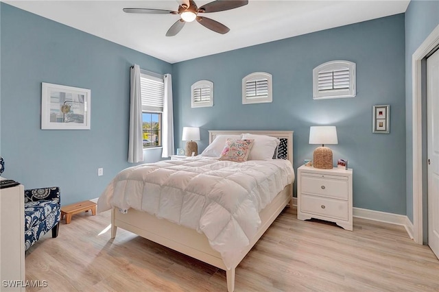 bedroom with light wood-style flooring, baseboards, and a ceiling fan
