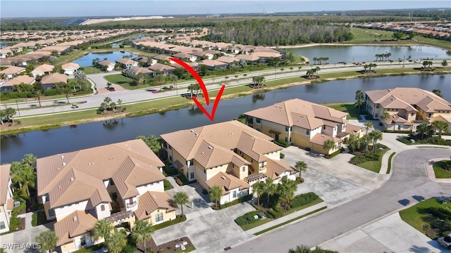 birds eye view of property featuring a residential view and a water view