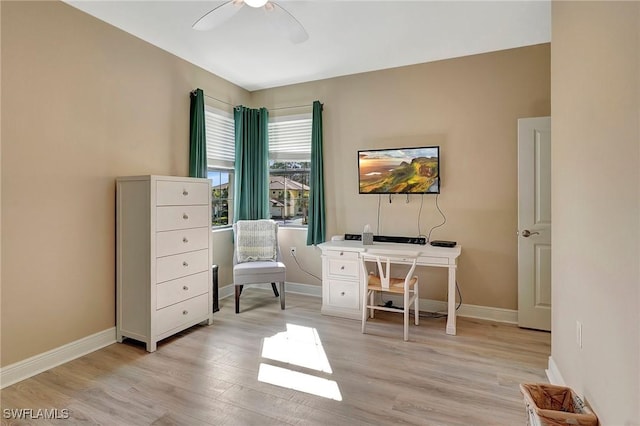 office space featuring light wood finished floors, baseboards, and ceiling fan