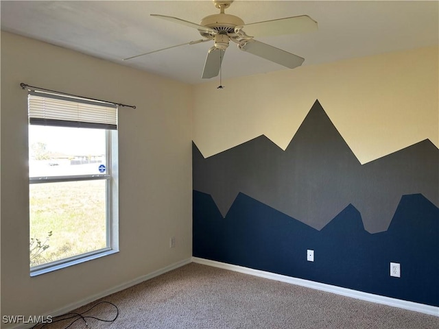 unfurnished room featuring carpet floors, baseboards, and a ceiling fan