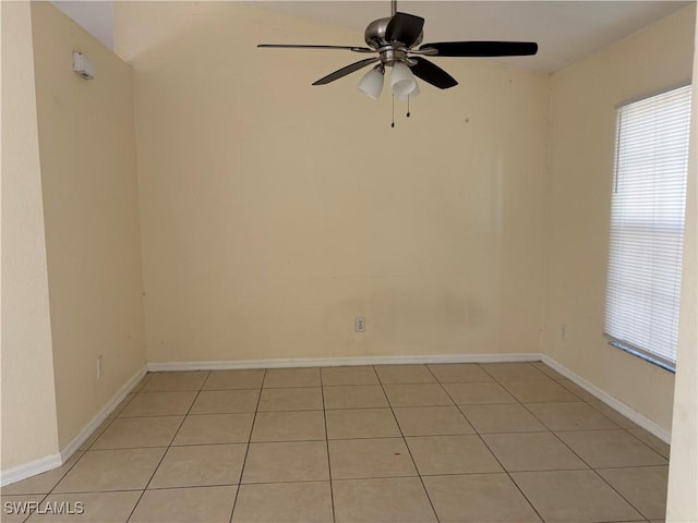 unfurnished room featuring a healthy amount of sunlight, ceiling fan, and baseboards