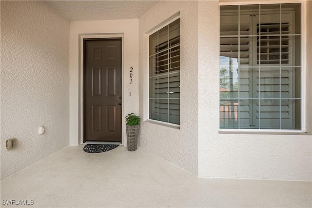 doorway to property with stucco siding