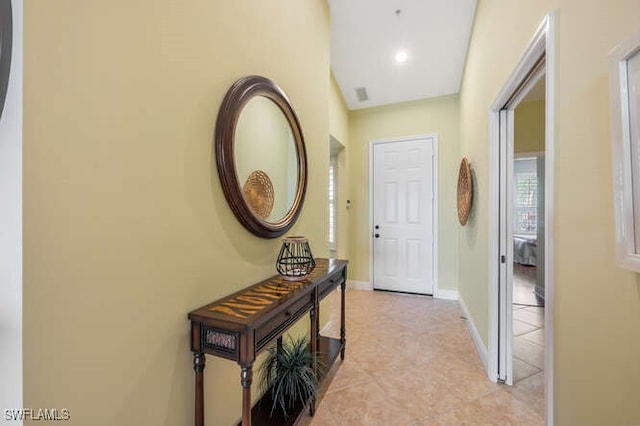 hallway featuring visible vents and baseboards