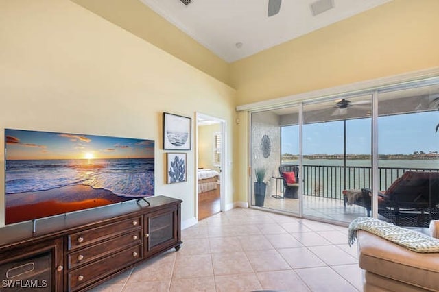 living room featuring light tile patterned floors, baseboards, and a ceiling fan