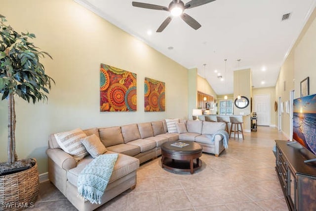 living room with light tile patterned floors, visible vents, baseboards, ceiling fan, and vaulted ceiling