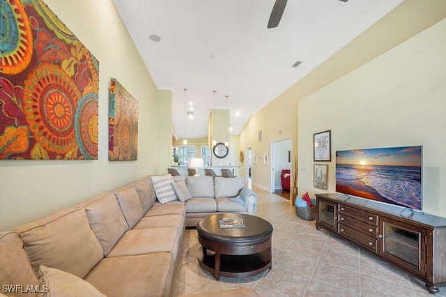 tiled living area with ceiling fan