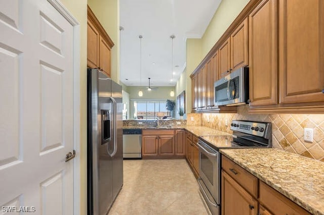 kitchen featuring stainless steel appliances, brown cabinetry, and decorative backsplash