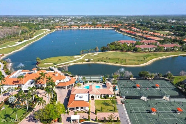 drone / aerial view featuring view of golf course and a water view