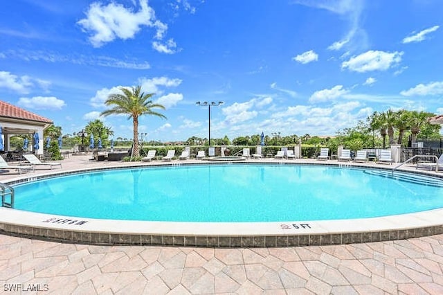 pool featuring a patio area and fence