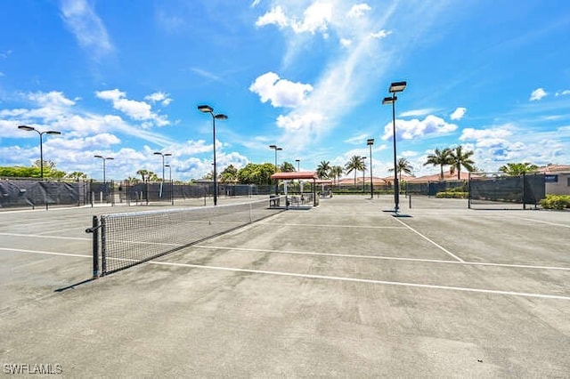 view of tennis court featuring fence