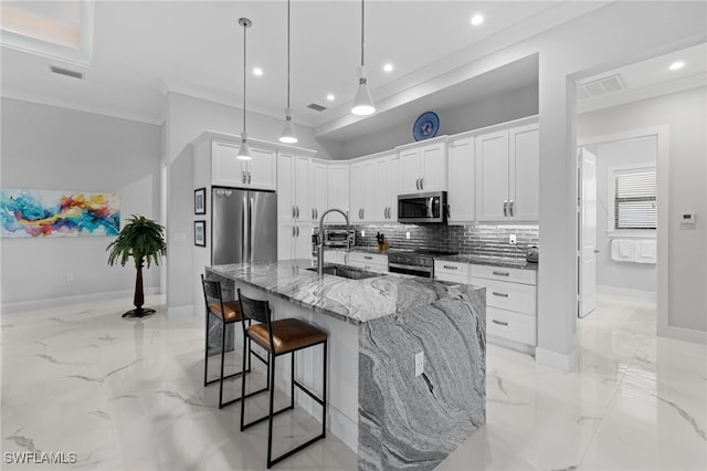 kitchen featuring light stone counters, stainless steel appliances, a breakfast bar, a sink, and marble finish floor