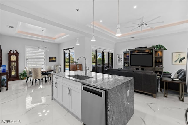 kitchen featuring light stone counters, a sink, marble finish floor, stainless steel dishwasher, and a tray ceiling