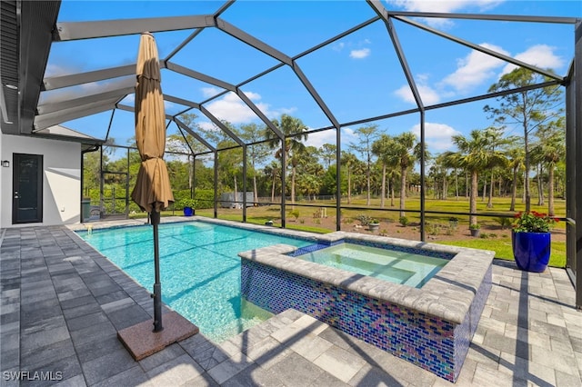 view of pool featuring glass enclosure, a pool with connected hot tub, and a patio area