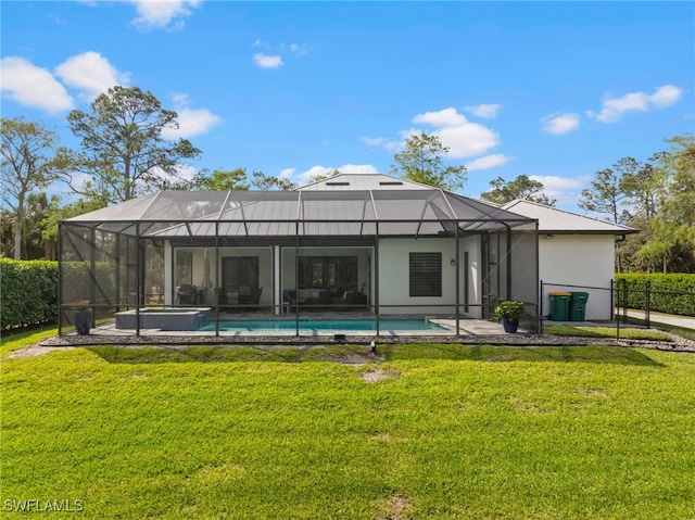 back of house with a lanai, a fenced in pool, fence, and a lawn