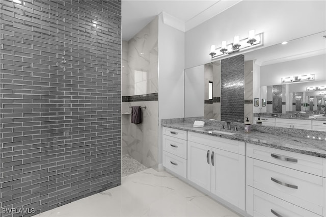 bathroom with marble finish floor, walk in shower, crown molding, and vanity