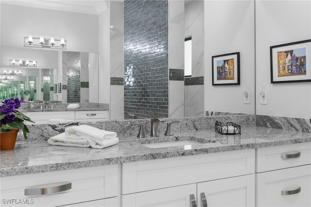 bathroom featuring ornamental molding and vanity