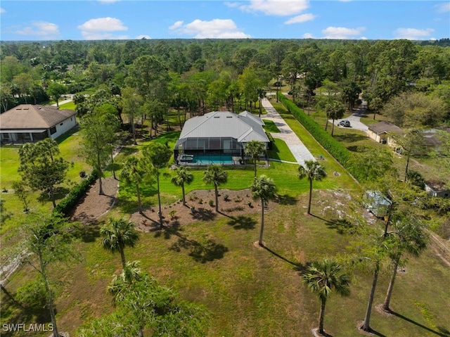 bird's eye view with a wooded view