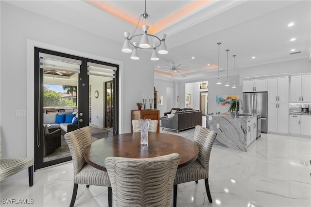 dining space with marble finish floor, a raised ceiling, french doors, and recessed lighting