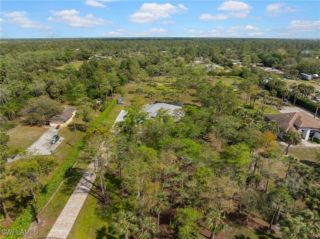 birds eye view of property with a view of trees