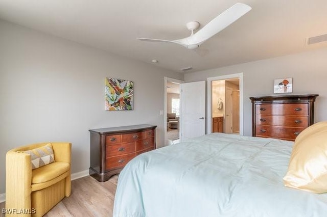 bedroom with light wood finished floors, ceiling fan, baseboards, and connected bathroom