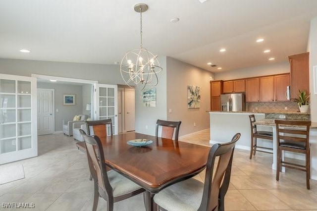 dining space with an inviting chandelier, baseboards, light tile patterned flooring, and recessed lighting