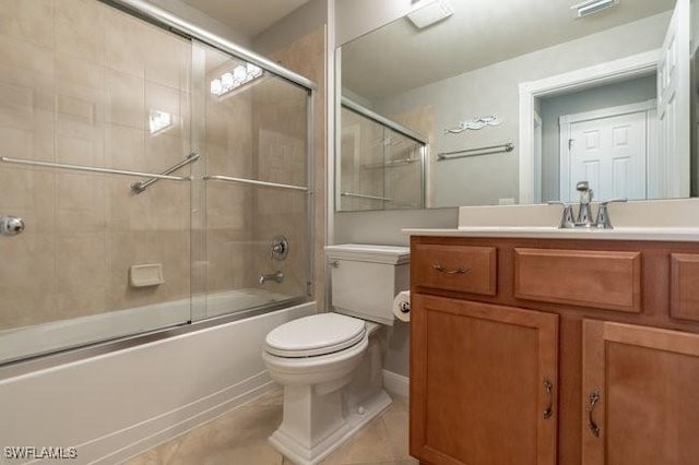 full bath with visible vents, toilet, shower / bath combination with glass door, tile patterned floors, and vanity