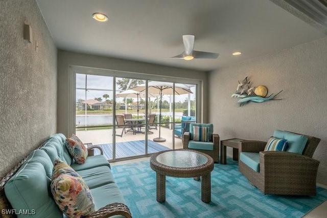 living area featuring a sunroom, recessed lighting, a ceiling fan, and a textured wall