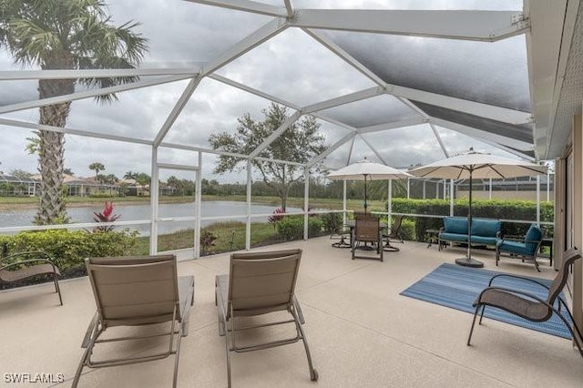 view of patio with glass enclosure, a water view, and an outdoor hangout area