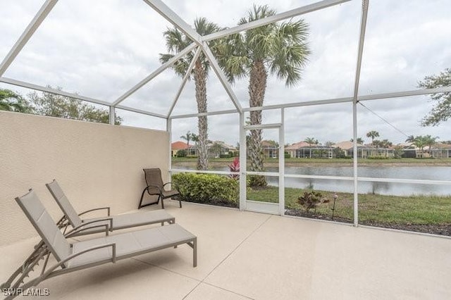 unfurnished sunroom featuring a water view