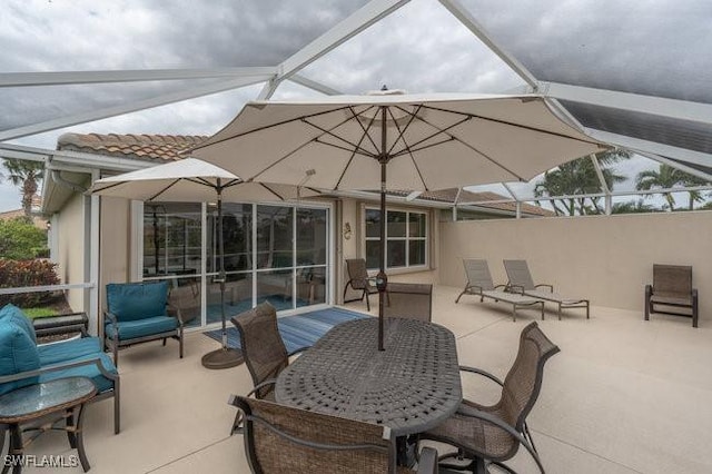 view of patio with glass enclosure