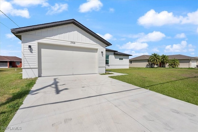 view of front of home with board and batten siding, a front yard, concrete driveway, and an attached garage