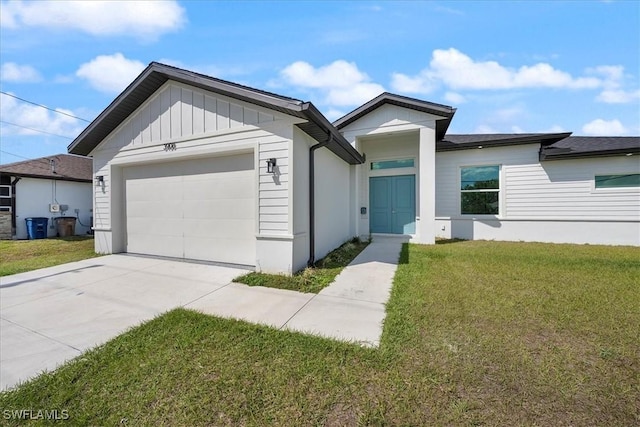 view of front facade with an attached garage, concrete driveway, board and batten siding, and a front yard