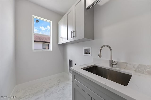 clothes washing area with cabinet space, marble finish floor, hookup for a washing machine, hookup for an electric dryer, and a sink