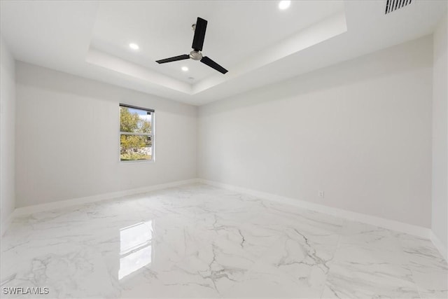 spare room featuring ceiling fan, recessed lighting, visible vents, baseboards, and a raised ceiling