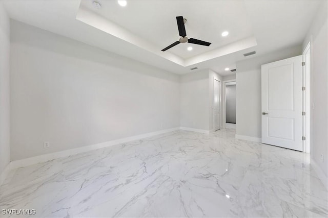 unfurnished room featuring recessed lighting, a raised ceiling, visible vents, ceiling fan, and baseboards