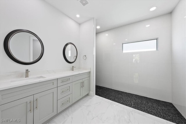 full bathroom with marble finish floor, double vanity, a sink, and recessed lighting