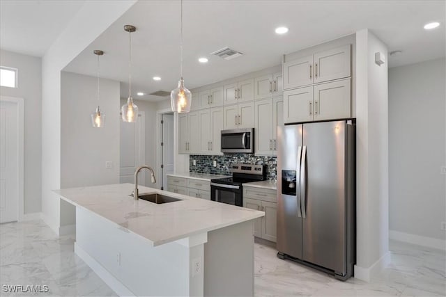 kitchen with appliances with stainless steel finishes, marble finish floor, and a sink