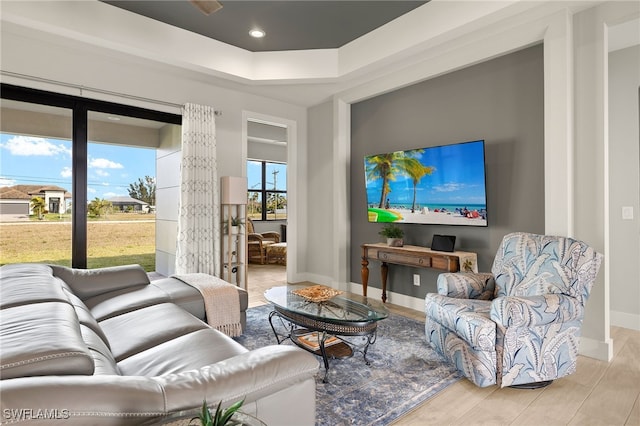 living room with recessed lighting, light wood finished floors, and baseboards