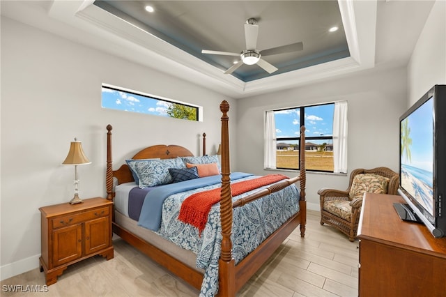 bedroom featuring baseboards, a raised ceiling, and a ceiling fan