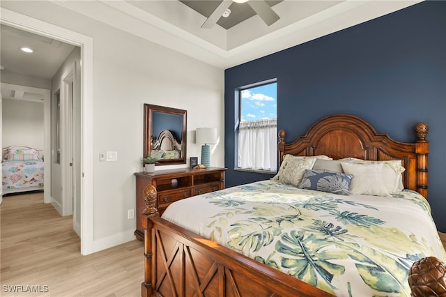 bedroom with light wood-type flooring, baseboards, and a ceiling fan