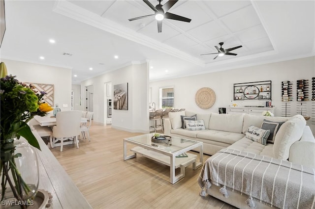 living area with recessed lighting, light wood-type flooring, a ceiling fan, and ornamental molding