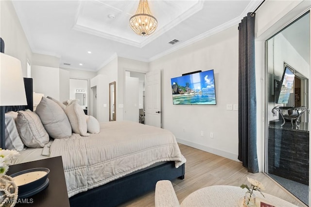 bedroom with visible vents, baseboards, light wood-style floors, crown molding, and a raised ceiling