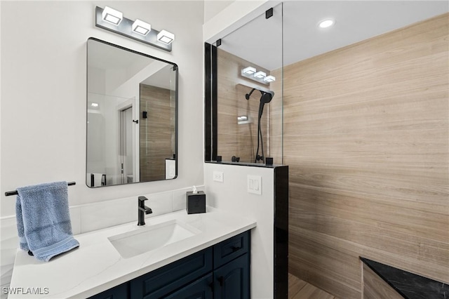 full bathroom with vanity and a walk in shower